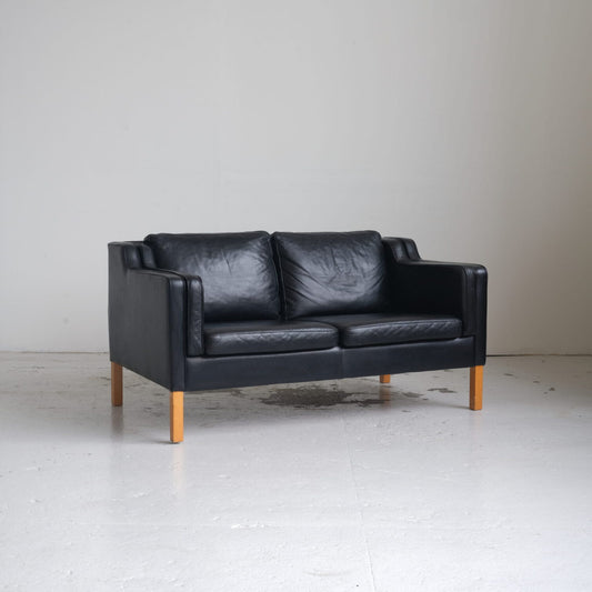 Danish furniture manufacturer. Two-person sofa, black leather